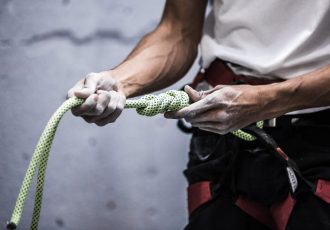 a-rock-climber-holds-out-knotted-rope