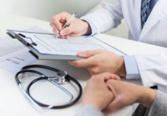 close-up-doctor-filling-medical-form-with-patient_23-2148050550-e1562869953353